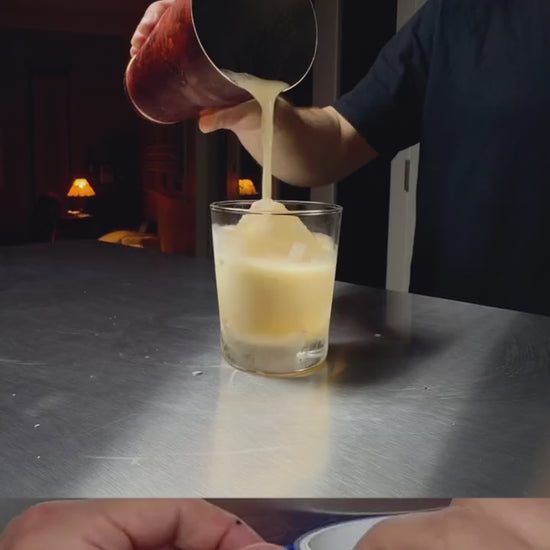 Making an amaretto sour with Cocktail Foamer — dense foam topping poured from a cocktail shaker