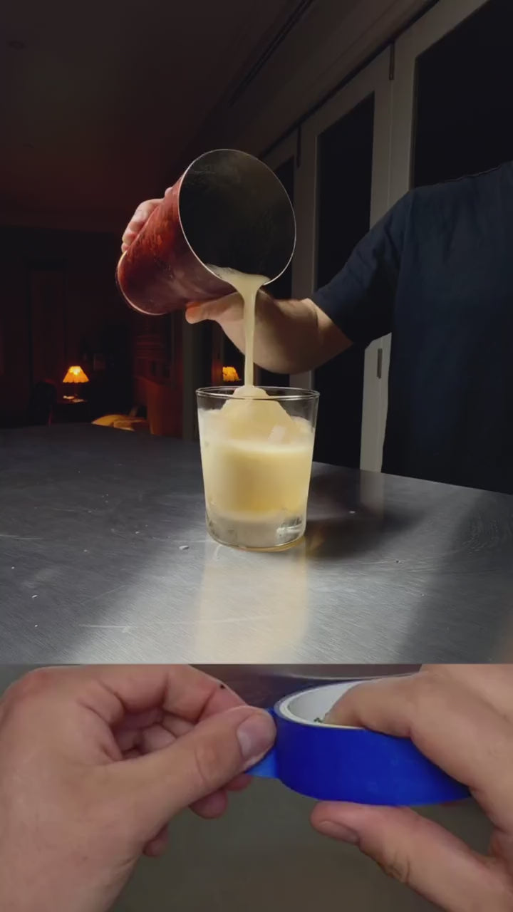 Making an amaretto sour with Cocktail Foamer — dense foam topping poured from a cocktail shaker